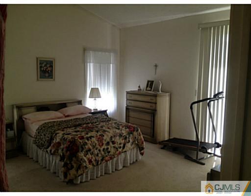 25 Riva Boulevard Brick, NJ 08723 - Photo 7 of 19 a bedroom with a bed and a window