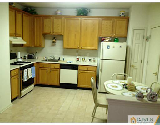 25 Riva Boulevard Brick, NJ 08723 - Photo 9 of 19 a kitchen with a sink appliances and cabinets