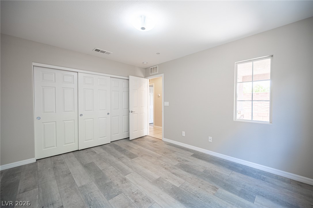 9916 Sable Point Street Las Vegas, NV 89178 - Photo 23 of 73 A spacious, airy bedroom with plank flooring and ample closet space.