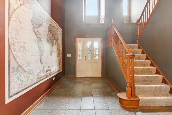 a view of entryway with bathroom and front door