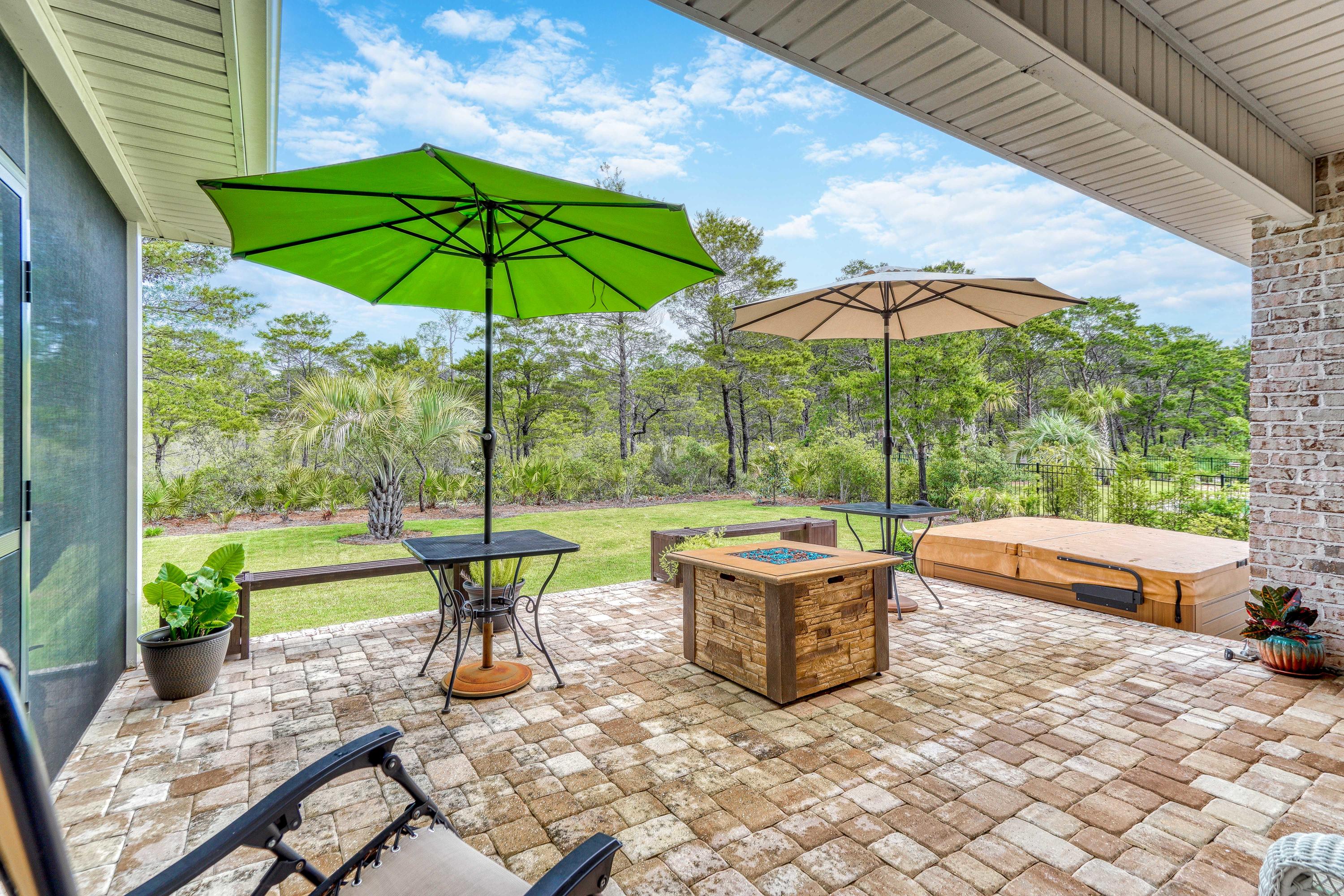 488 Ridge Road Santa Rosa Beach, FL 32459 - Photo 33 of 46 a view of a patio with chairs and umbrellas