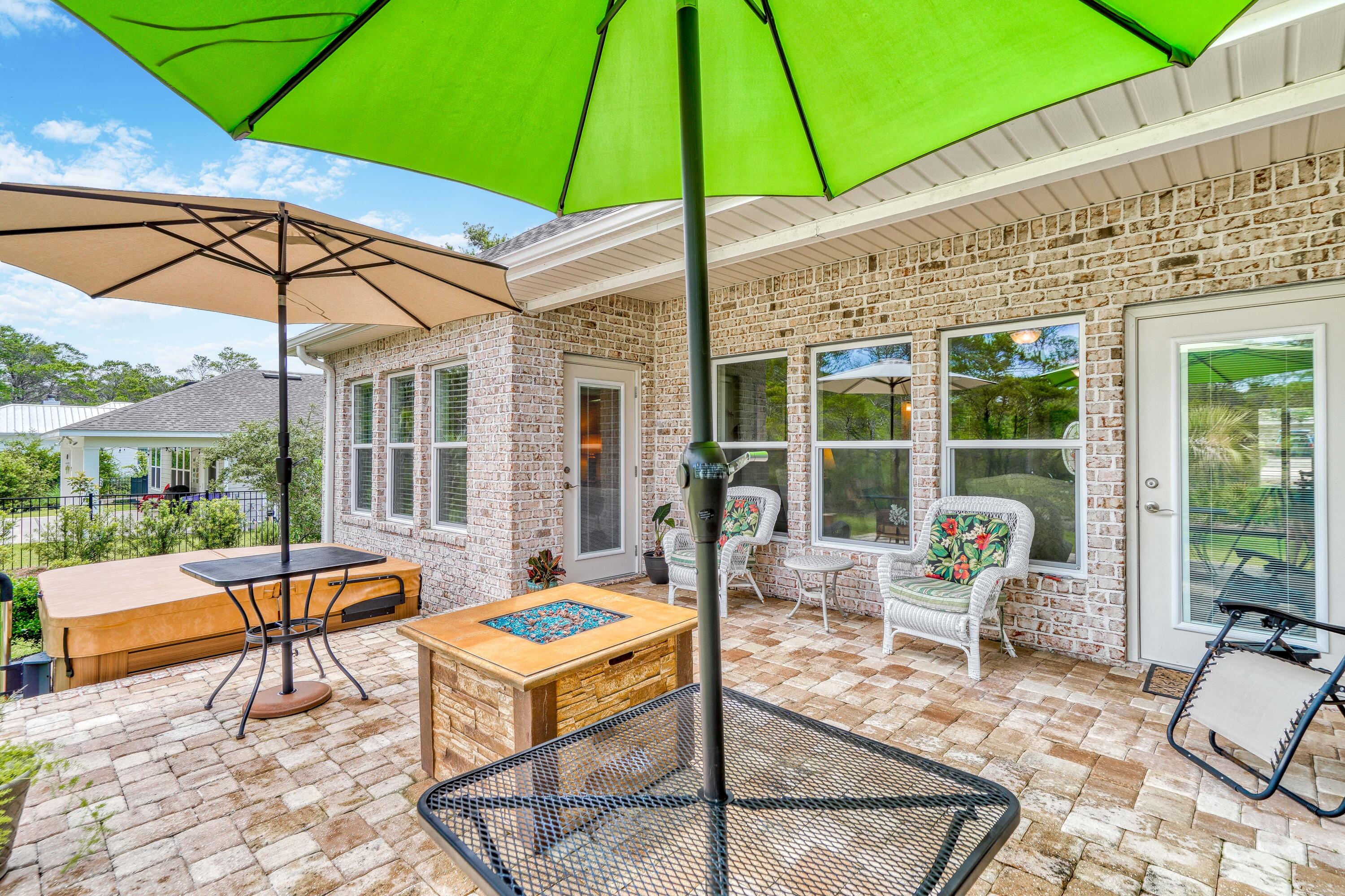 488 Ridge Road Santa Rosa Beach, FL 32459 - Photo 35 of 46 a patio with a table and chairs under an umbrella