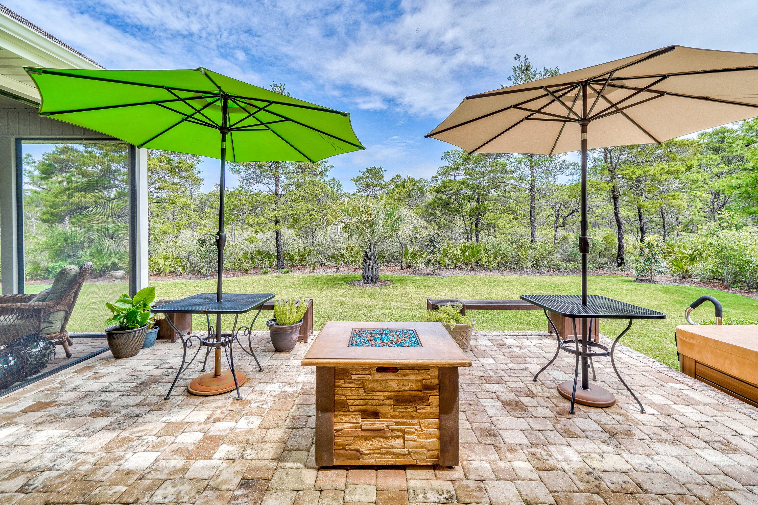 488 Ridge Road Santa Rosa Beach, FL 32459 - Photo 36 of 46 a view of a chairs and table under an umbrella in backyard