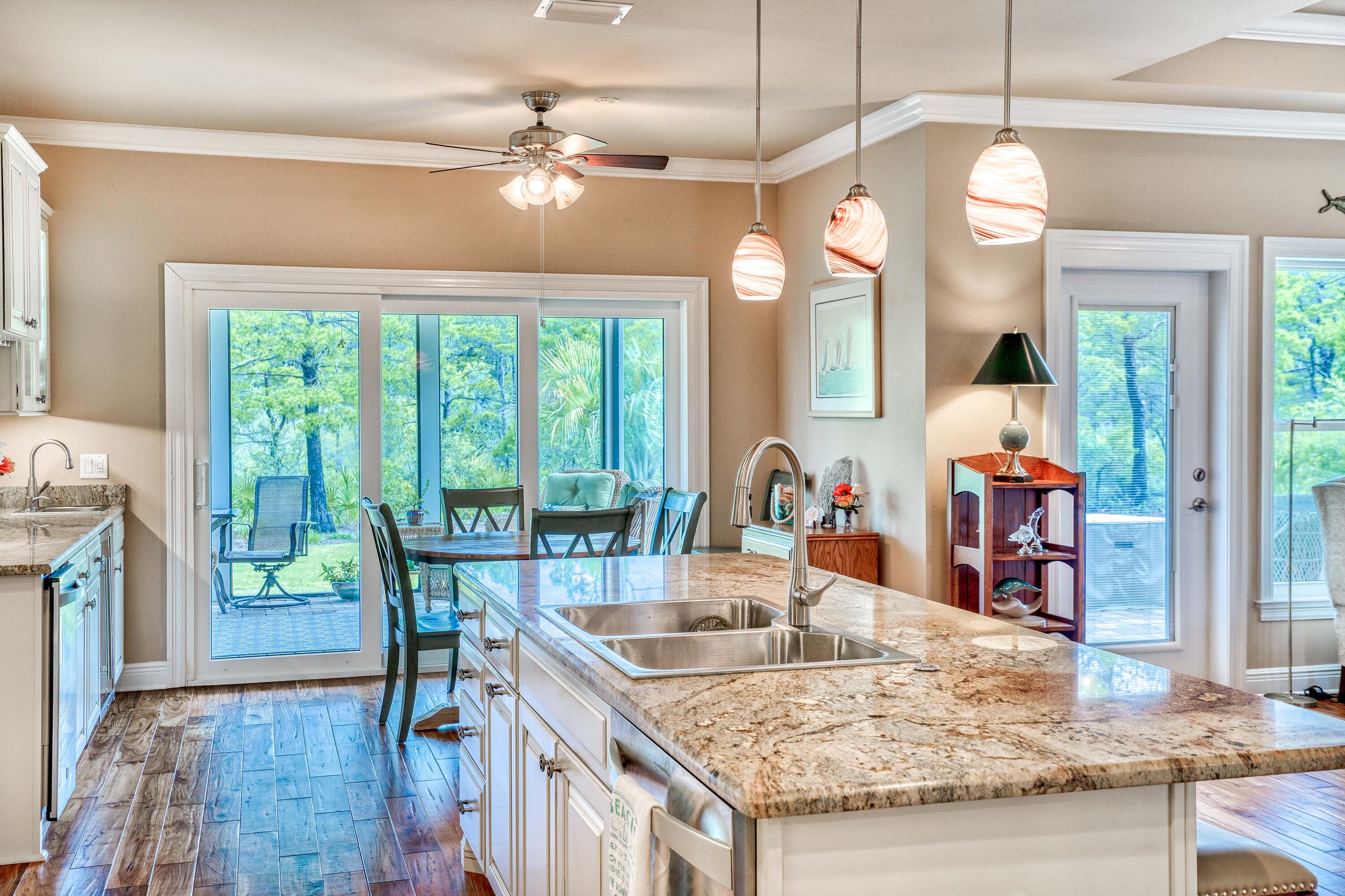 488 Ridge Road Santa Rosa Beach, FL 32459 - Photo 6 of 46 a dining table with chairs and a chandelier