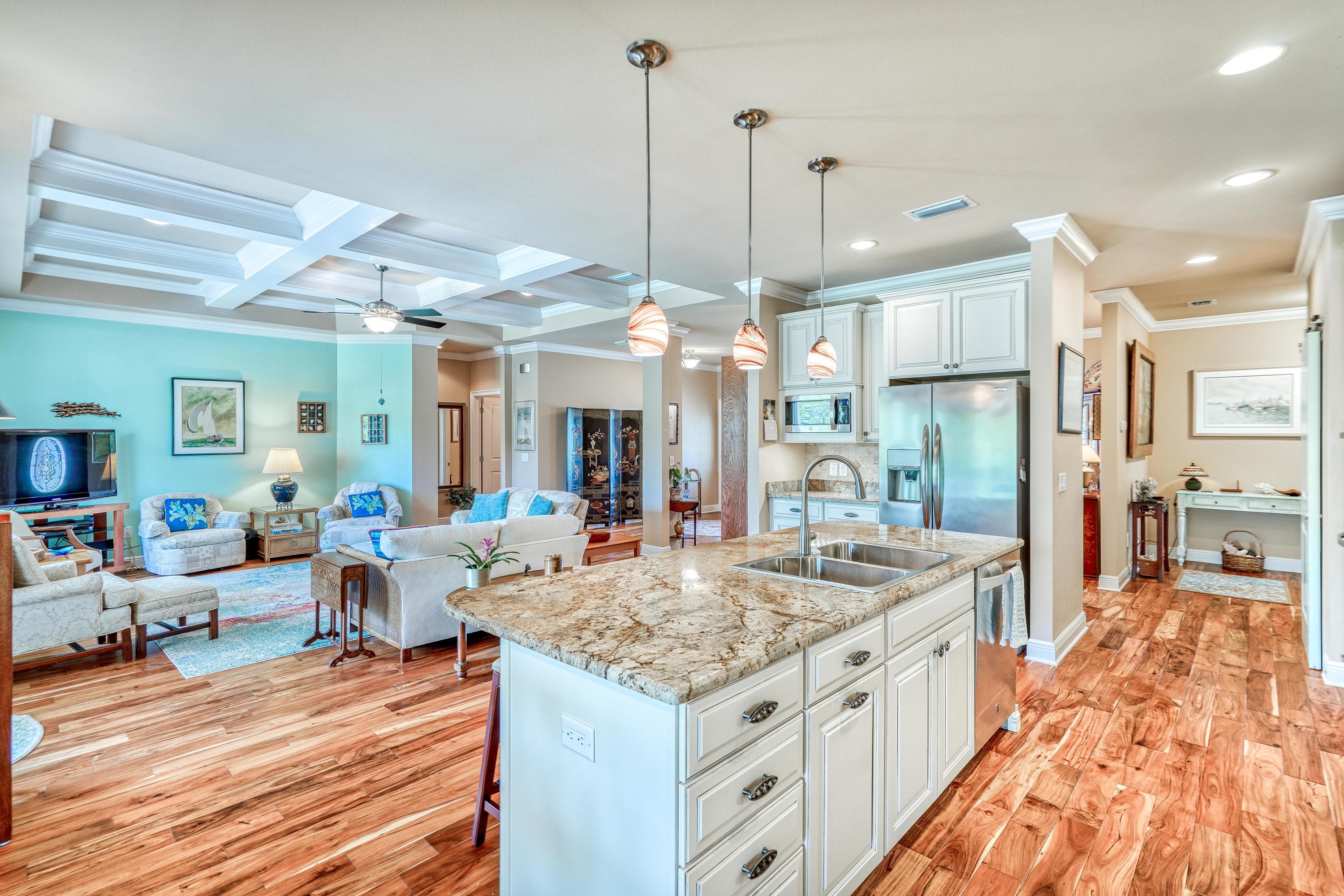 488 Ridge Road Santa Rosa Beach, FL 32459 - Photo 7 of 46 a large kitchen with kitchen island a large counter top space a sink appliances and living room view