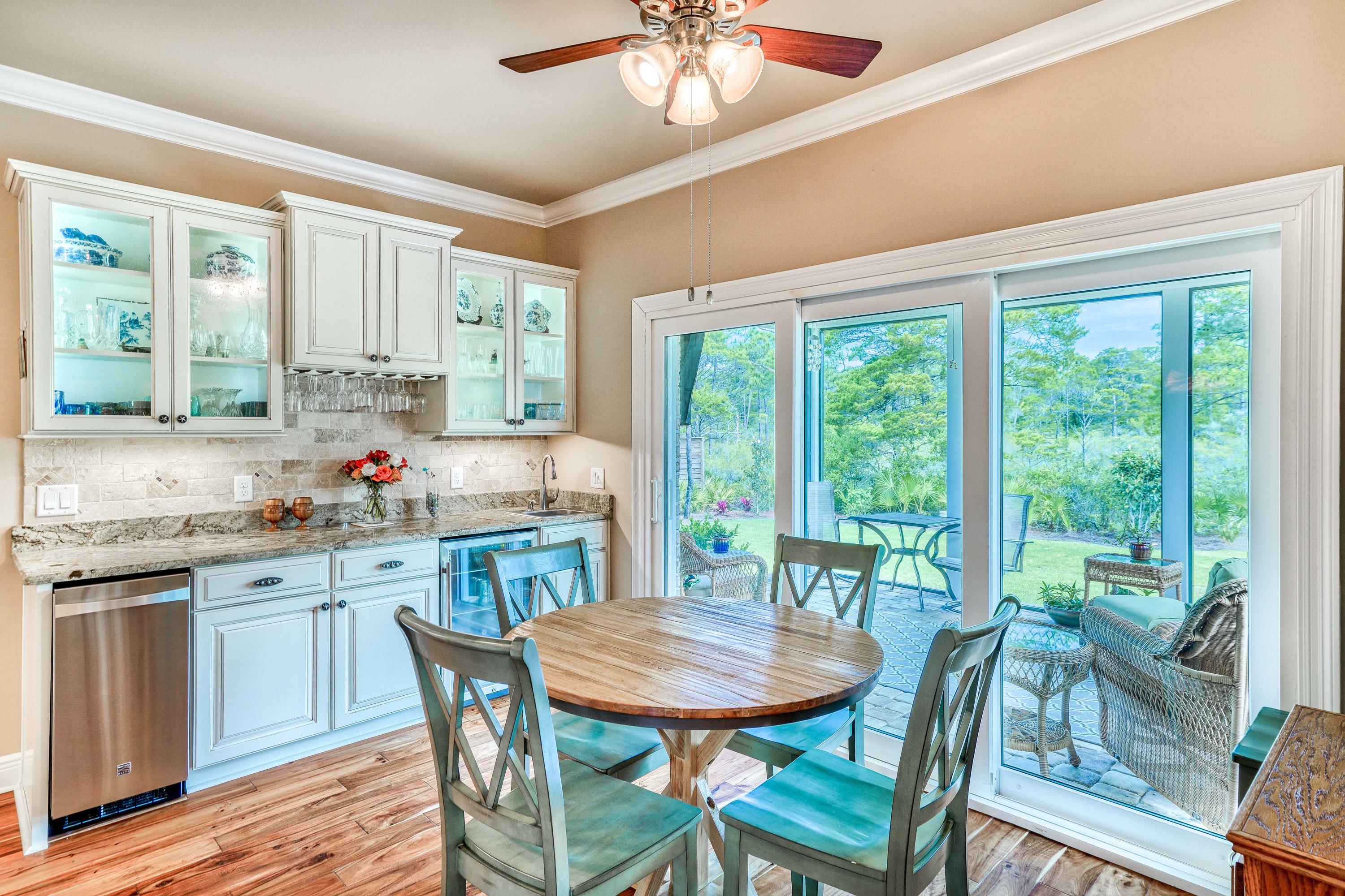 488 Ridge Road Santa Rosa Beach, FL 32459 - Photo 8 of 46 a kitchen with kitchen island granite countertop wooden floor dining table and chairs