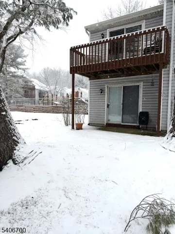 a view of a house with a wooden roof deck