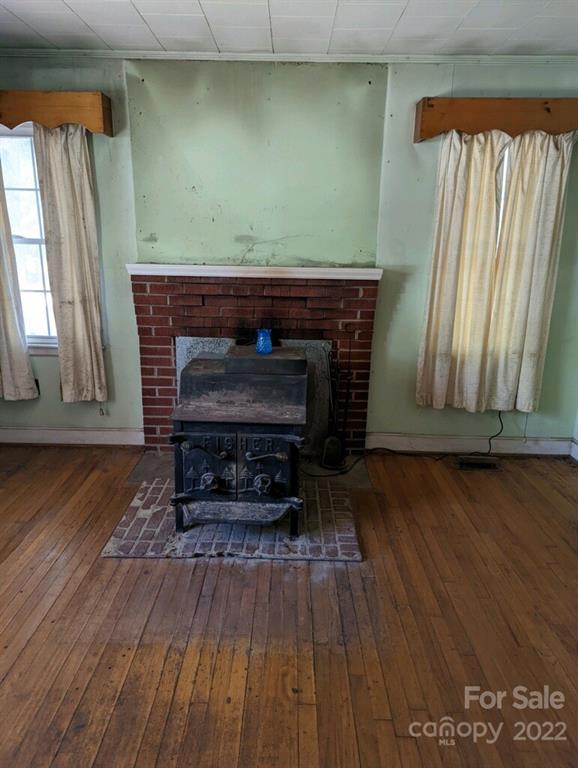4839 Tabernacle Road Lancaster, SC 29720 - Photo 14 of 23 a living room with a fireplace and a wooden floor