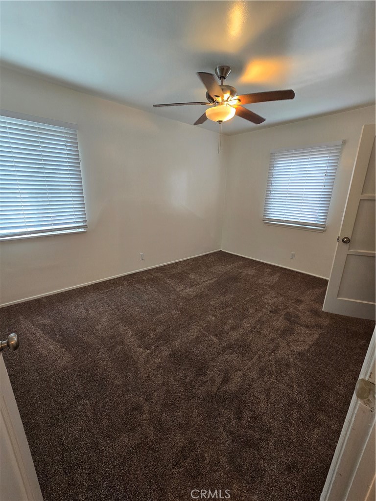9542 Rex Road Pico Rivera, CA 90660 - Photo 8 of 11 an empty room with windows and fan