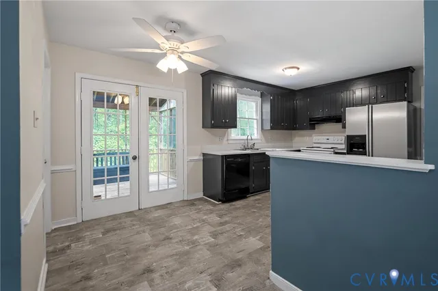 a view of a kitchen with a sink cabinets and a large window