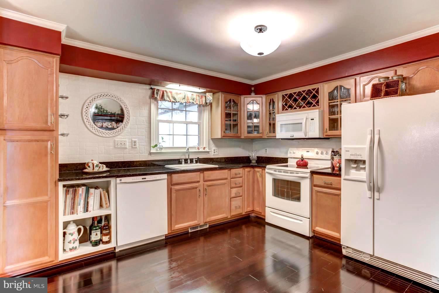 104 Cedar Street Chestertown, MD 21620 - Photo 7 of 16 a kitchen with stainless steel appliances a stove a refrigerator and a window
