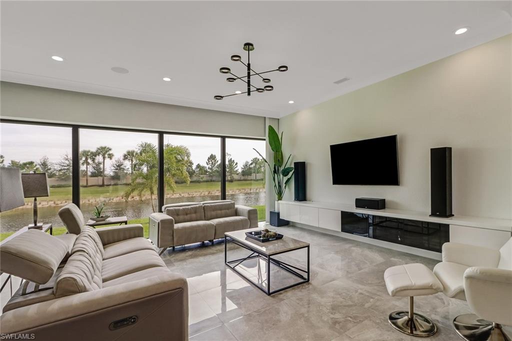 4410 Caldera Circle Naples, FL 34119 - Photo 12 of 35 a living room with furniture and a flat screen tv