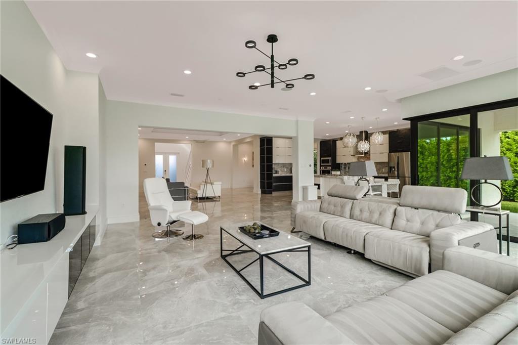 4410 Caldera Circle Naples, FL 34119 - Photo 13 of 35 a living room with furniture and a flat screen tv