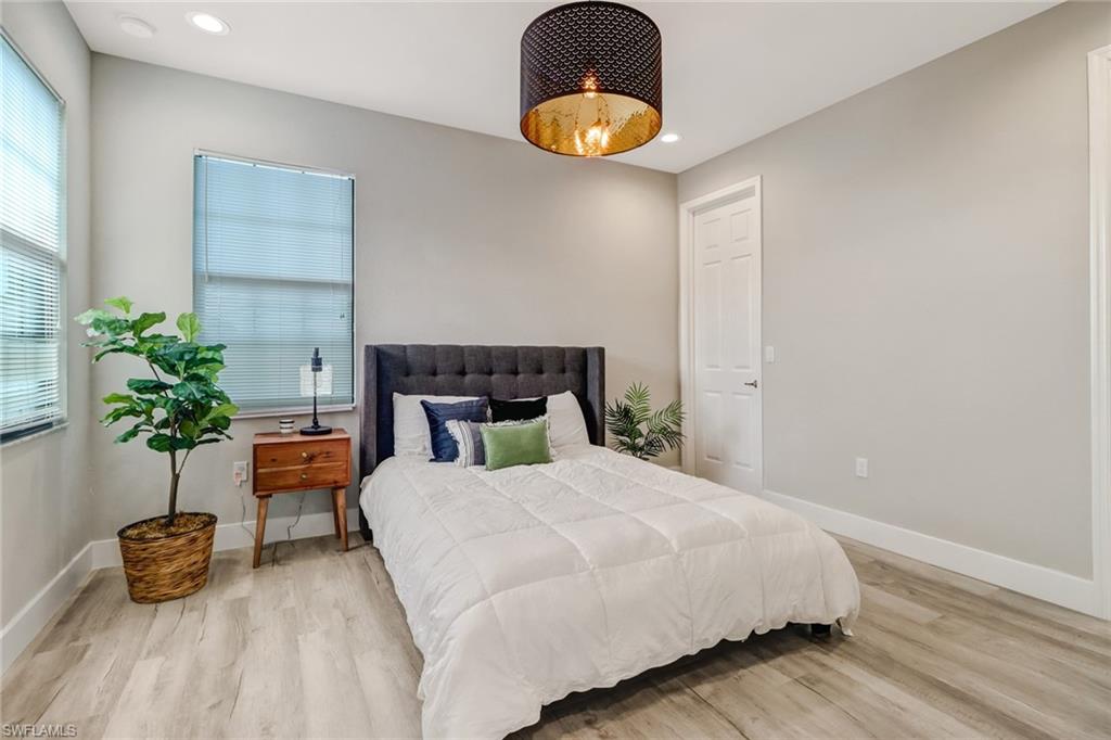 4410 Caldera Circle Naples, FL 34119 - Photo 20 of 35 a bedroom with bed and a potted plant