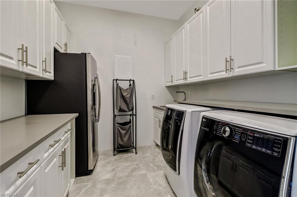 4410 Caldera Circle Naples, FL 34119 - Photo 21 of 35 a utility room with refrigerator and washer