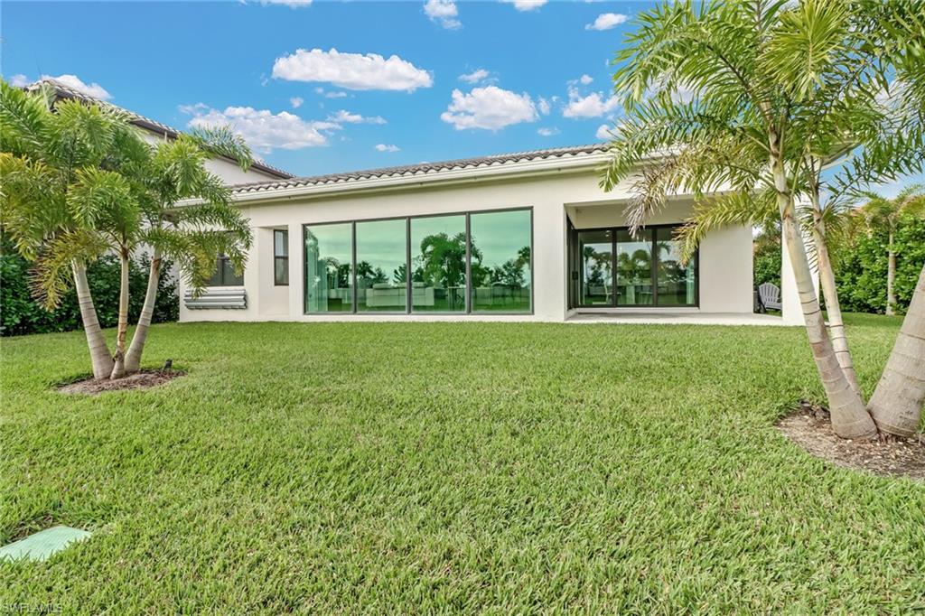 4410 Caldera Circle Naples, FL 34119 - Photo 22 of 35 a view of a house with a big yard and potted plants