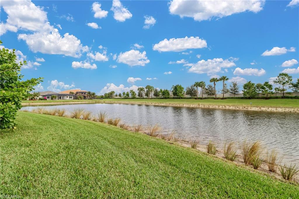 4410 Caldera Circle Naples, FL 34119 - Photo 23 of 35 a view of a lake with houses in the back