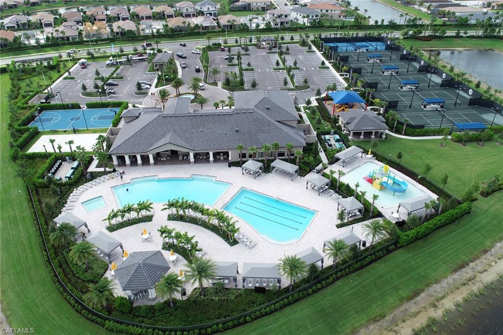 4410 Caldera Circle Naples, FL 34119 - Photo 26 of 35 an aerial view of residential houses with outdoor space and lake view