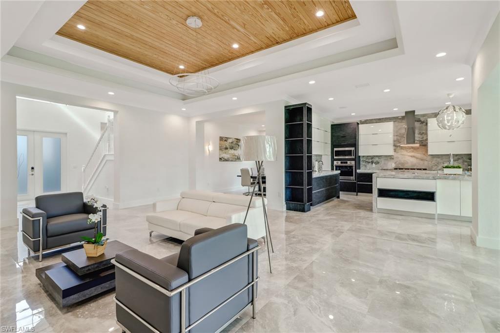 4410 Caldera Circle Naples, FL 34119 - Photo 5 of 35 a living room with furniture and kitchen view