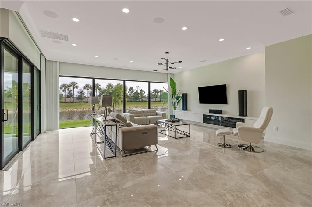 4410 Caldera Circle Naples, FL 34119 - Photo 10 of 35 a living room with furniture and a flat screen tv
