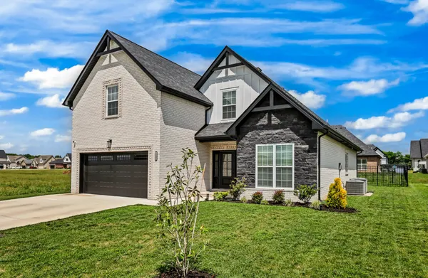 a front view of a house with a yard and garage