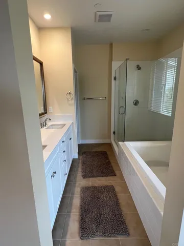 a bathroom with a tub sink and mirror