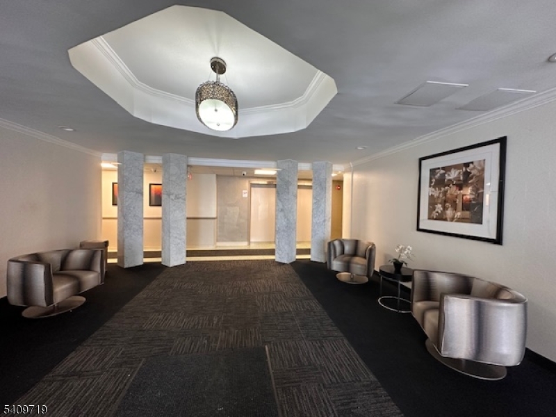 77 Prospect Avenue, Unit D Hackensack, NJ 07601 - Photo 12 of 14 a living room with furniture and a large window