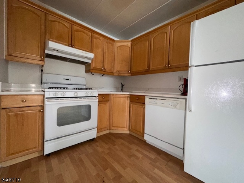 77 Prospect Avenue, Unit D Hackensack, NJ 07601 - Photo 3 of 14 a kitchen with cabinets appliances and wooden floor