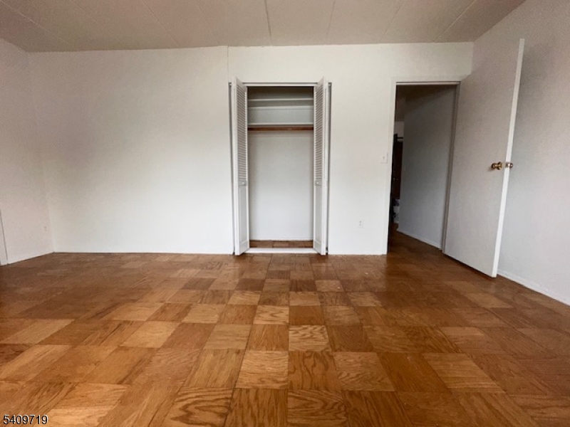 77 Prospect Avenue, Unit D Hackensack, NJ 07601 - Photo 5 of 14 an empty room with a natural light