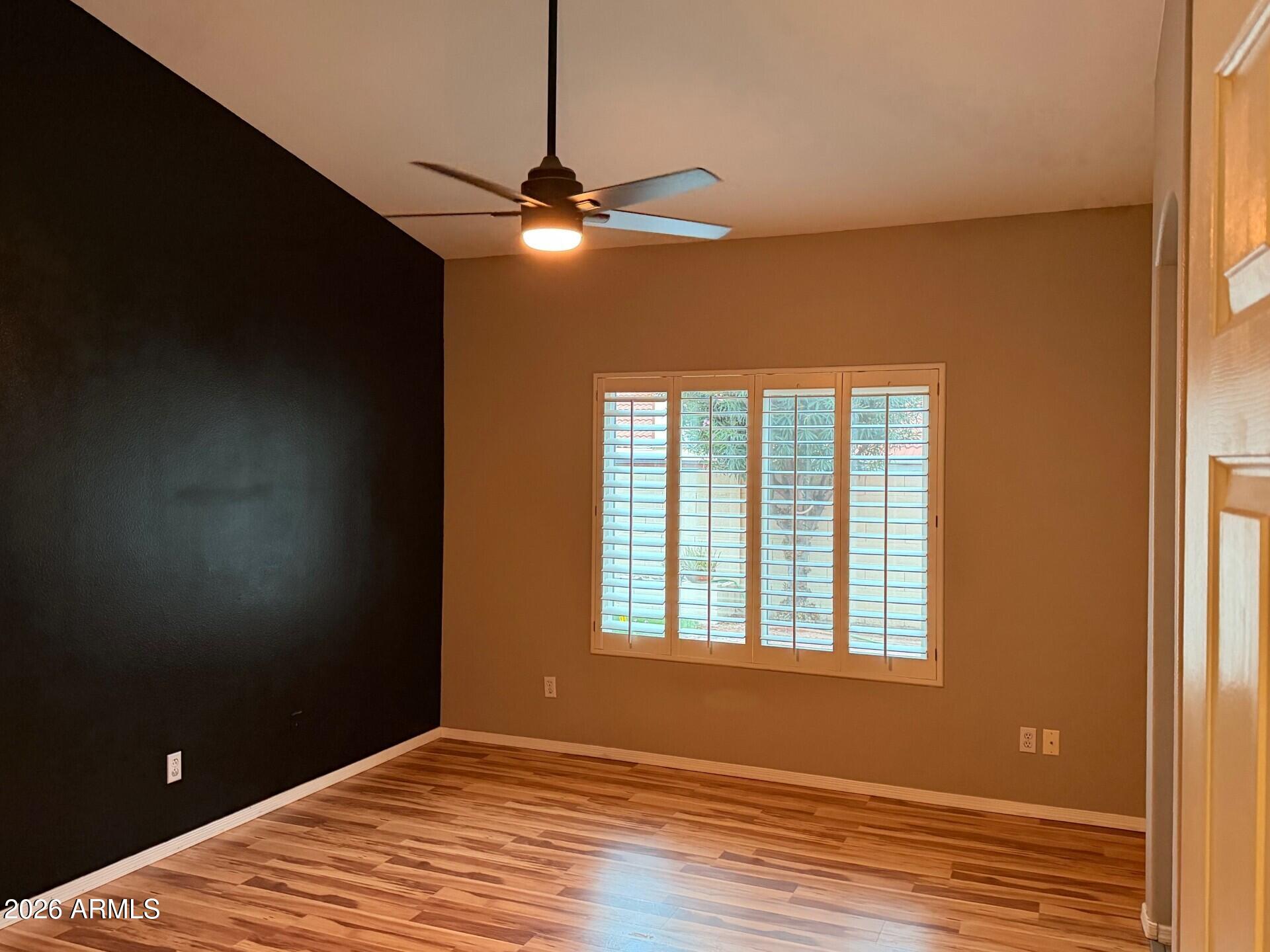 4906 East Brown Road, Unit 14 Mesa, AZ 85205 - Photo 4 of 10 a view of a livingroom with a ceiling fan and window