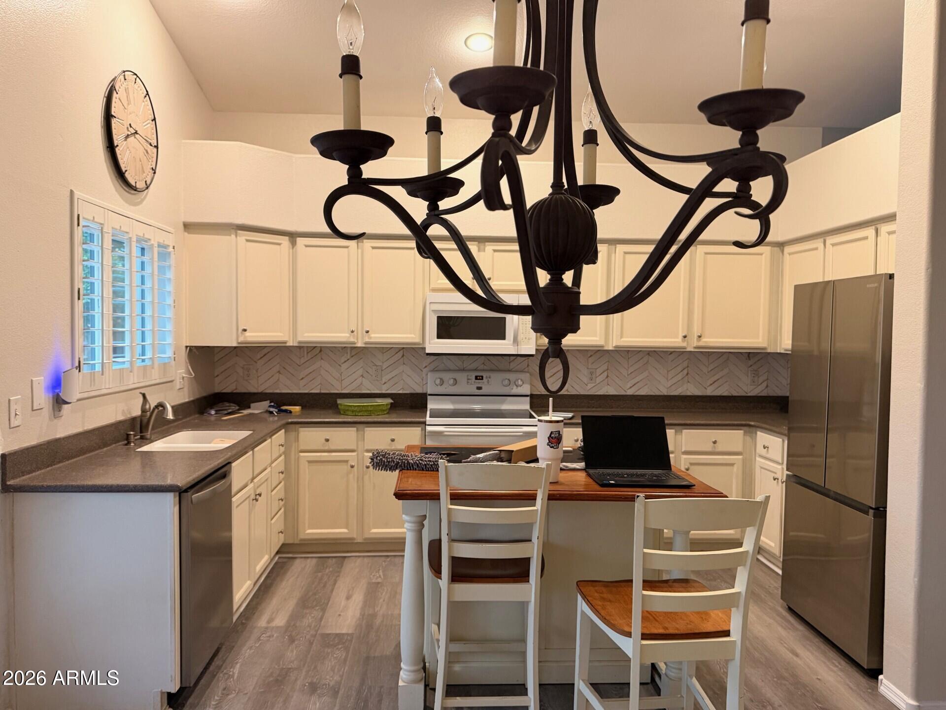 4906 East Brown Road, Unit 14 Mesa, AZ 85205 - Photo 6 of 10 a kitchen with stainless steel appliances granite countertop a stove and a microwave