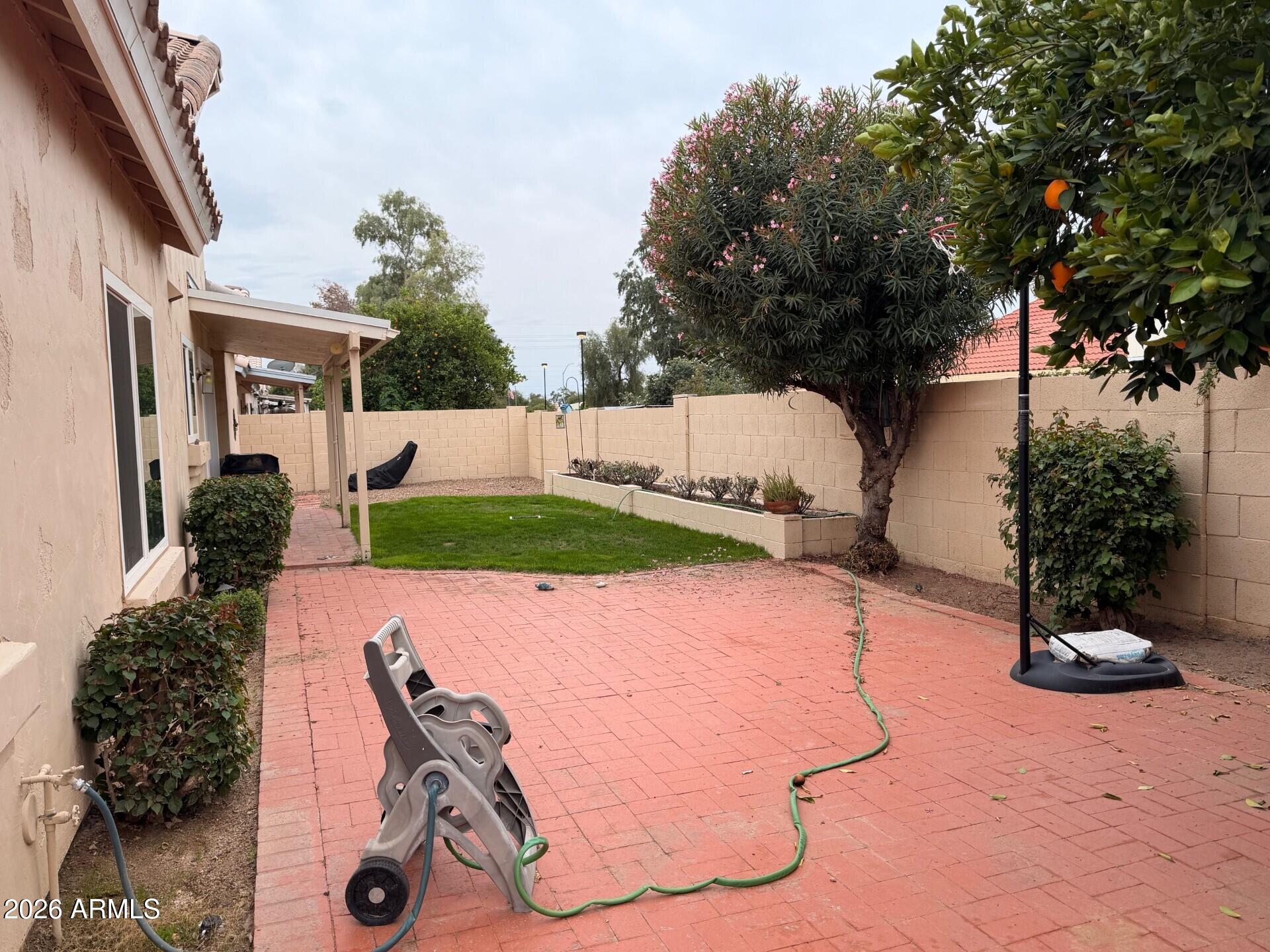 4906 East Brown Road, Unit 14 Mesa, AZ 85205 - Photo 7 of 10 a view of a backyard with table and chairs potted plants