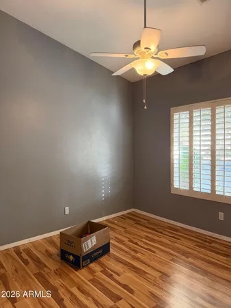 a room with a window and ceiling fan