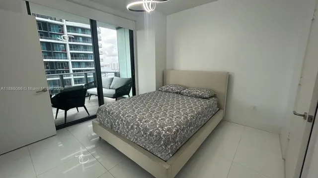 a living room with furniture and a floor to ceiling window