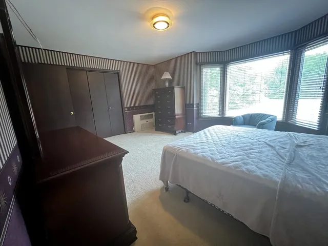 a bedroom with a bed and a window