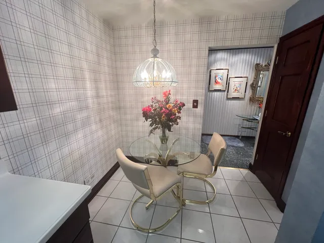 a dining room with furniture and chandelier