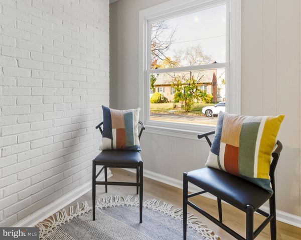 a view of a workspace with a window and a chair