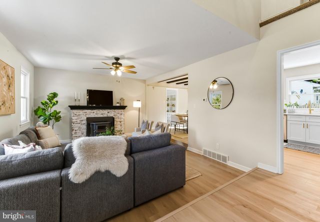 a living room with furniture a fireplace and a window