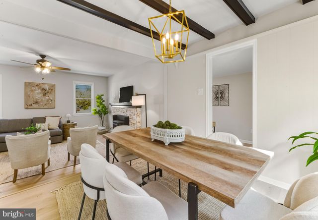 a view of a dining room with furniture and a chandelier