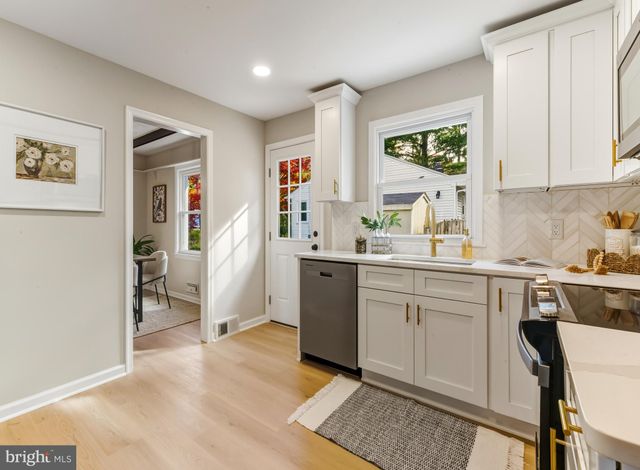 a kitchen with a sink cabinets and window