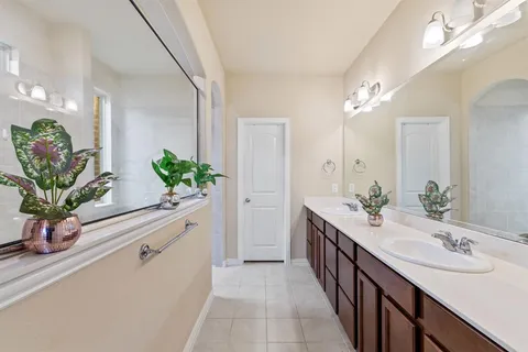 a bathroom with a double vanity sink and a mirror