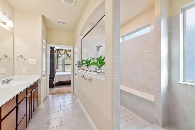 a bathroom with a bathtub sink and mirror