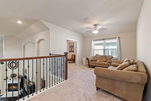 a living room with furniture ceiling fan and a rug