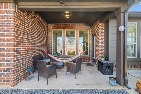 a view of a house with a backyard and sitting area