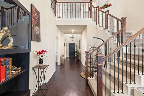 a dining room with furniture entryway and wooden floor