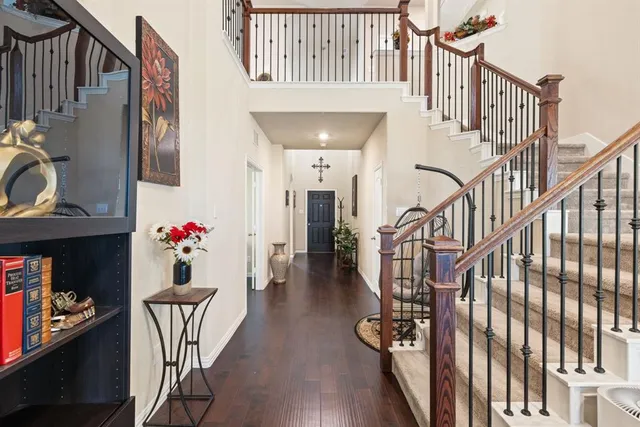 a dining room with furniture entryway and wooden floor