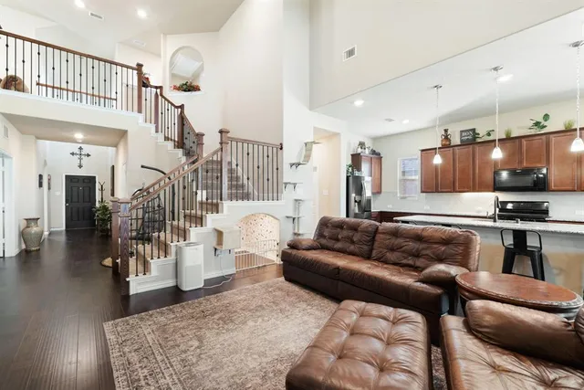 a living room with furniture and kitchen view