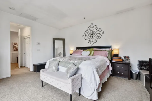 a bedroom with a bed and a lamp on table