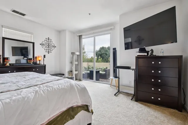 a bedroom with a bed and a flat screen tv