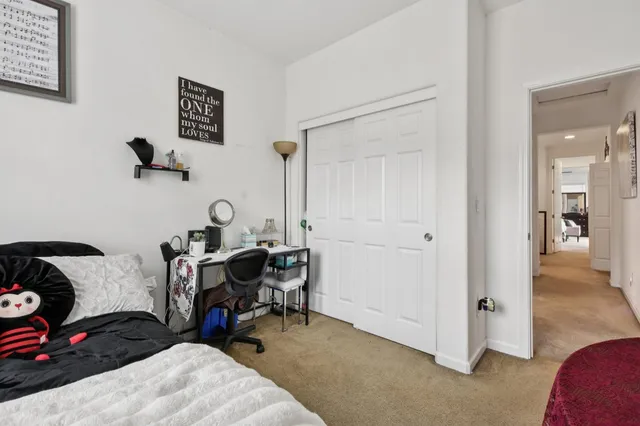 a bedroom with a bed and a painting on the wall